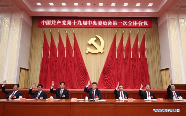Xi Jinping (C), Li Keqiang (3rd R), Li Zhanshu (3rd L), Wang Yang (2nd R), Wang Huning (2nd L), Zhao Leji (1st R) and Han Zheng (1st L) attend the first plenary session of the 19th Communist Party of China (CPC) Central Committee at the Great Hall of the People in Beijing, capital of China, Oct. 25, 2017. [Photo: Xinhua]